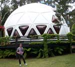John in front of his unusual dome house.
