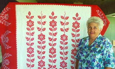 La Dona Anick with the quilt made by her mother-in-law Rose Mary Anick