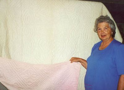 Joyce Wynn with her mother-in-law's quilt