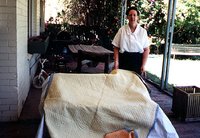 Angela Smith with her grandmother's quilt.