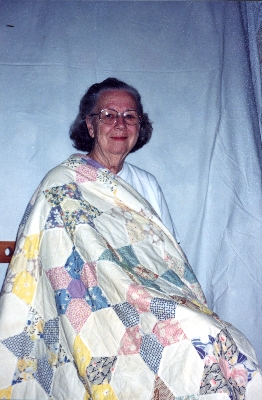 Alyce Wright with her grandmother's quilt