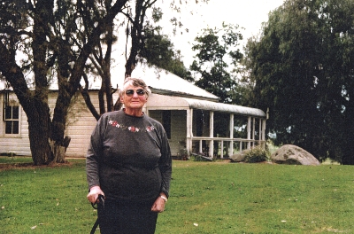 Bessie outside the house where she grew up, 1998
