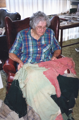 Nancy looking at her baby dress, 2000